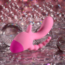 Selopa Game On Triple Stimulation Vibrator Pink next to sparkling bubbles on a reflective surface.