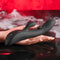 Playboy That's The Spot Dual G-Spot Vibrator with Tapping Feature in hand, 10 speeds, black, red background with mist.