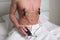 Black vibrating nipple clamps applied to a man's chest, with adjustable tension and remote for multiple vibration settings.