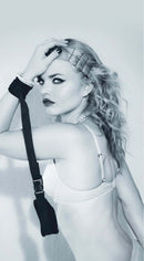 Model showcasing Sex & Mischief Adjustable Handcuffs in a playful pose, emphasizing comfort and style.