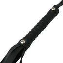 Close-up of the handle of the Sex & Mischief Faux Leather Flogger, featuring a textured grip and metal accents.