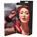 Model wearing Sportsheets Saffron Handcuffs, showcasing bold red design on wrist restraints for a striking look.