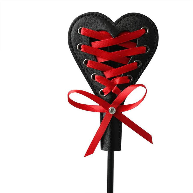 Black and red heart-shaped crop with laces and ribbon, perfect for playful spanking and intimate fun.