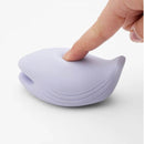Tenga Iroha Plus Yorukujira Sumire Massager in soft violet with a finger pressing on its surface.
