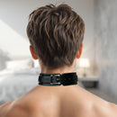 Back view of a person wearing a Strict Leather Deluxe Locking Collar in a modern bedroom setting.