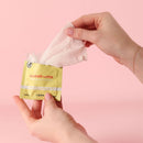 Sweetums Pina Colada Flavored Intimate Wipes being pulled from packaging for fresh and playful intimate care.