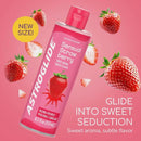 Astroglide Strawberry Water Based Flavored Lube 8.5 Oz bottle with strawberries in the background.