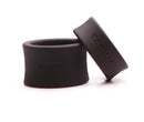 Two soft silicone ball stretchers from Tantus in black, designed for safe scrotum stretching and enhanced pleasure.