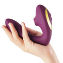Tracy's Dog OG Clitoral Sucking Vibrator Purple held in hand, showcasing its ergonomic design for pleasure.