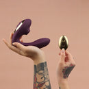 Tracy's Dog OG2 Clitoral Sucking Vibrator Purple with wireless remote control in hand.