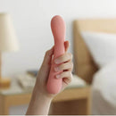 A person holding the Tenga Iroha Mai Toki, an advanced personal massager, showcasing its ergonomic design.