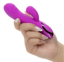 Kroma Turbo Passion Silicone Dual Stimulator Purple held in hand, showcasing its sleek design and flexible dual-tip feature.