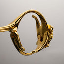 Close-up of UPKO Ripple Metal Handcuffs design showcasing polished gold finish and intricate detail.