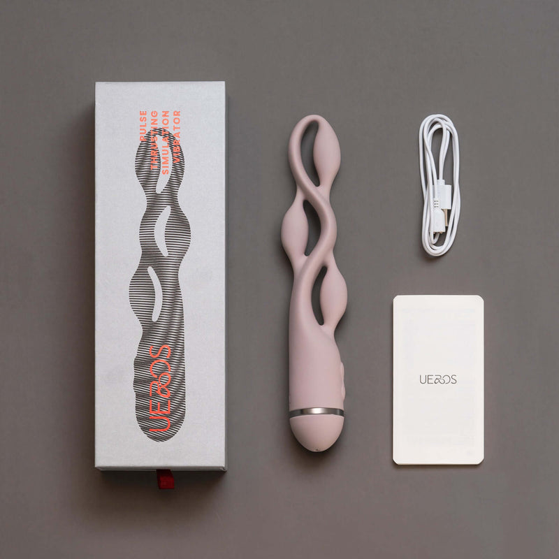 UEROS pink multi-motor pulse vibrator with unique design, packaging box, charging cable, and instruction manual displayed.