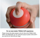 Hand holding Tenga Original Vacuum Cup Strong with sticker instructions for better suction experience.