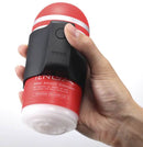 Person holding Tenga Cup Vibrating Masturbator, showcasing its ergonomic design and functionality.