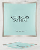 Warm Human Condoms Go Here Glass Trinket Tray displaying the phrase 'Condoms Go Here' on a decorative dish.