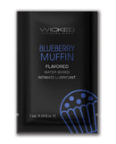 Wicked Sensual Care Water Based Lubricant Blueberry Muffin flavored intimate lubricant packet.