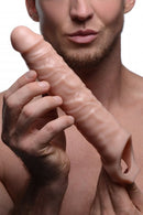 Man holding Size Matters 3 inches Penis Flesh Extender Sleeve, showcasing its realistic design and texture.