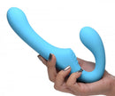 Strap U Mighty Rider 10X Vibrating Strapless Strap On Blue held in a hand showcasing its smooth design and functionality.