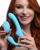 Strap U Mighty Rider 10X Vibrating Strapless Strap On Blue held by a smiling woman, showcasing its sleek design and vibrant color.