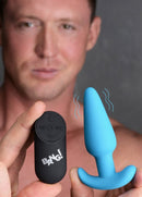 Bang 21X Vibrating Silicone Butt Plug with Remote Control Blue and remote in hands of a person, showcasing design.