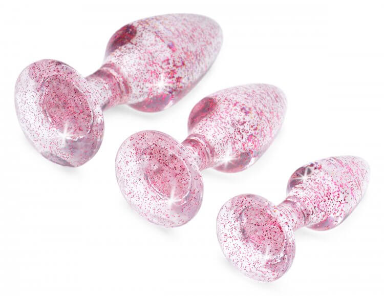 Booty Sparks Glitter Gem Anal Plug Set in pink, showcasing three tapered plugs in S/M/L sizes with shiny glittery pattern.