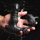 Thunder Plugs 10X Thrusting Vibrator with Cock & Ball Strap held in wet hand to showcase its waterproof design.