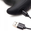 Close-up of Thunder Plugs 10X Thrusting Vibrator with Cock & Ball Strap USB charging port and cable.