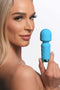 Bang! 10X Mini Silicone Rechargeable Wand in blue held by a model, showcasing its sleek design for discreet pleasure.