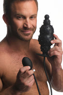 Master Series Ass Puffer Nubbed Inflatable Silicone Anal Plug showcased by a man holding the device with a pump