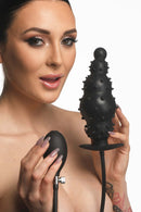 Master Series Ass Puffer Nubbed Inflatable Silicone Anal Plug in use with a model holding the inflatable plug and remote.
