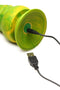 Close-up of Monstropus 2.0 Vibrating Tentacle Silicone Dildo in marbled green with yellow and blue pattern, connected to a USB charger.