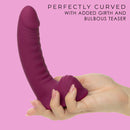 G-Ride Road Trip Dual Motor Vibrating Dildo 6.75 inch Red displayed in hand, showcasing its curved design and girth.