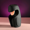 Evolved Lick the Tip Vibrating Tongue Stroker Black on a pink surface with a purple background.