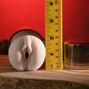 Zero Tolerance Riley Reid Mini Stroker Vagina next to a ruler, showcasing its compact size and realistic texture.