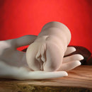 Zero Tolerance Riley Reid Mini Stroker Vagina held in a hand with a soft texture, perfect for discreet use.