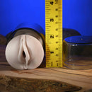 Zero Tolerance Sasha Grey Mini Stroker Vagina with measuring tape for size reference on a wooden surface.