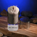 Zero Tolerance Sasha Grey Mini Stroker Vagina displayed on a natural wood surface with a calming blue glow.