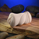 Zero Tolerance Sasha Grey Mini Stroker Vagina on a wooden surface with stones, showcasing its realistic design.