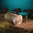 Zero Tolerance Dani Daniels Mini Stroker Vagina displayed in its container on a wooden surface.