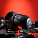 Zero Tolerance Wet It Be vibrating lubricating stroker ring on black stones with red background