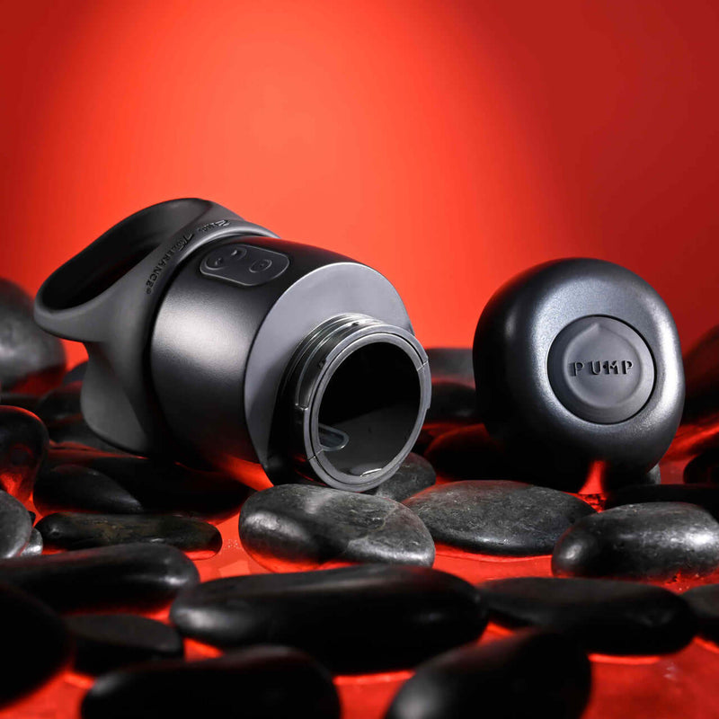 Zero Tolerance Wet It Be vibrating lubricating stroker ring on black stones with red background.