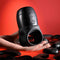 Zero Tolerance Wet It Be vibrating lubricating stroker ring in hand against a red background with black stones.