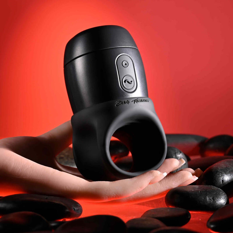 Zero Tolerance Wet It Be vibrating lubricating stroker ring in hand against a red background with black stones.
