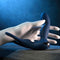 Hand holding Zero Tolerance By All Means remote control prostate vibrator with flexible shaft and ball ring
