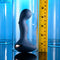 Zero Tolerance Blue Oasis vibrating silicone plug with measuring tape showcasing its size against a blue background.