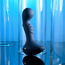 "Zero Tolerance Blue Oasis vibrating silicone plug with ergonomic design on reflective surface"