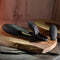 Zero Tolerance Nautilus rechargeable dual cock ring on a wooden surface, showcasing sleek black silicone design and remote control.