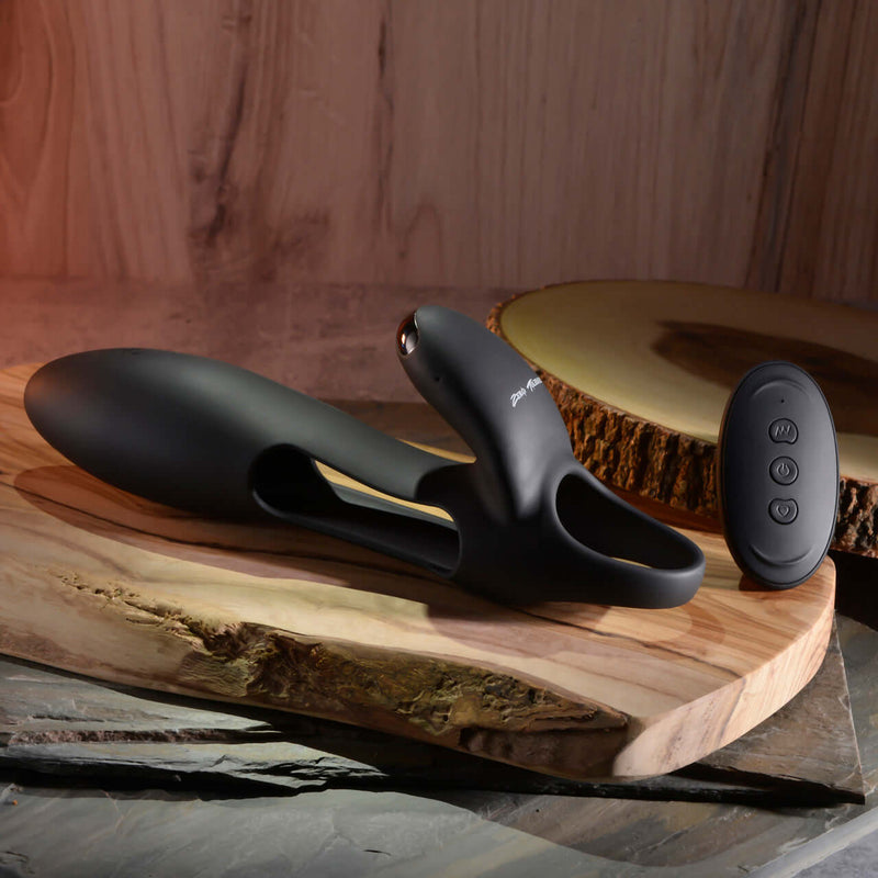 Zero Tolerance Nautilus rechargeable dual cock ring on a wooden surface, showcasing sleek black silicone design and remote control.